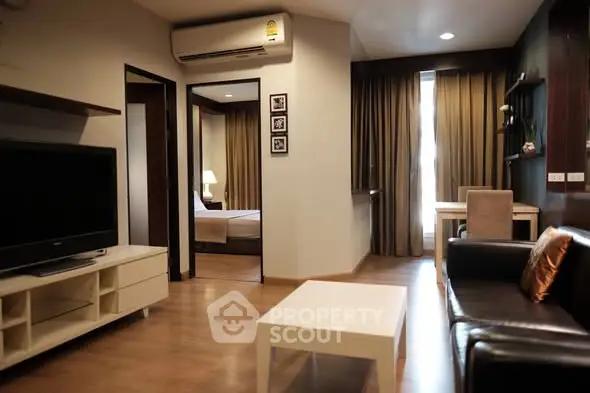 Modern living room with sleek furniture and open layout in stylish apartment.