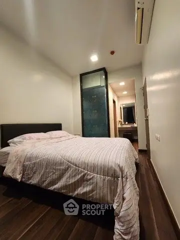 Cozy bedroom with modern design and wooden flooring