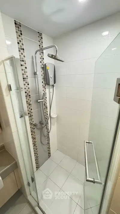 Modern bathroom with glass shower enclosure and sleek fixtures