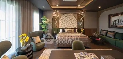 Luxurious bedroom with elegant decor and cozy seating area, perfect for relaxation.