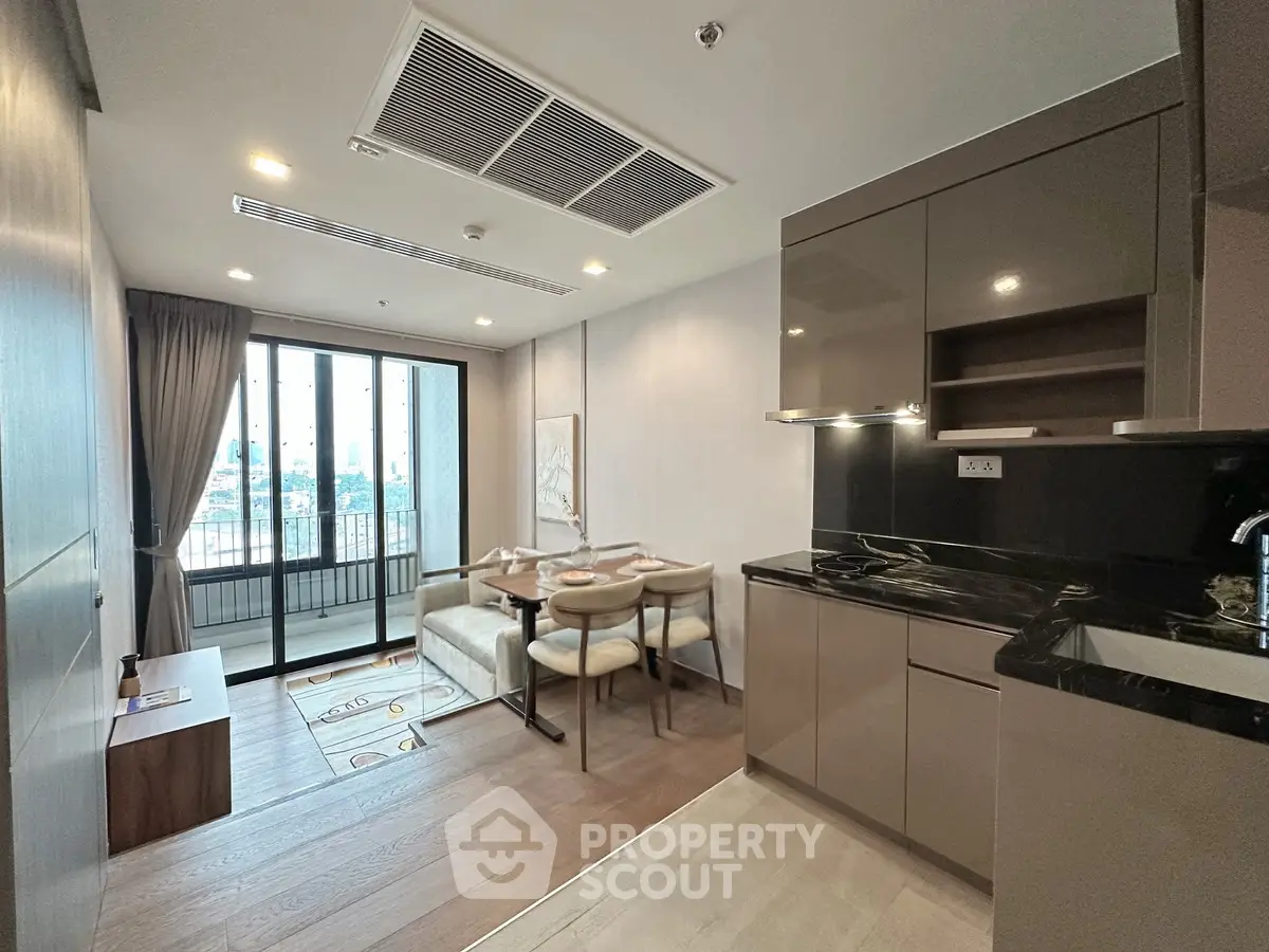 Modern open-plan kitchen and dining area with city view balcony