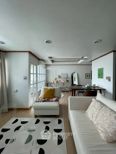 Stylish living room with modern decor and open layout, featuring cozy seating and elegant lighting.