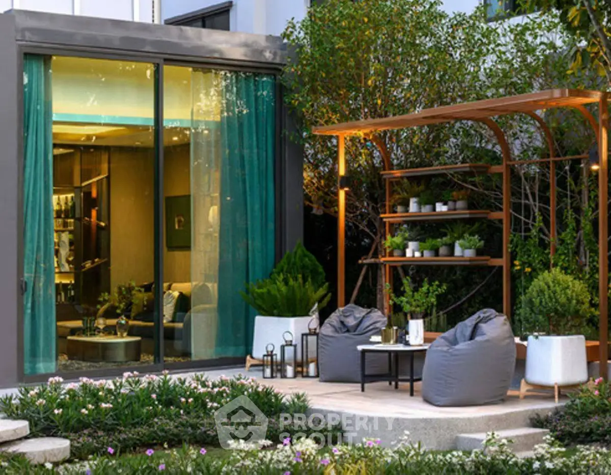 Luxurious garden patio with modern seating and lush greenery, perfect for relaxation and entertaining.