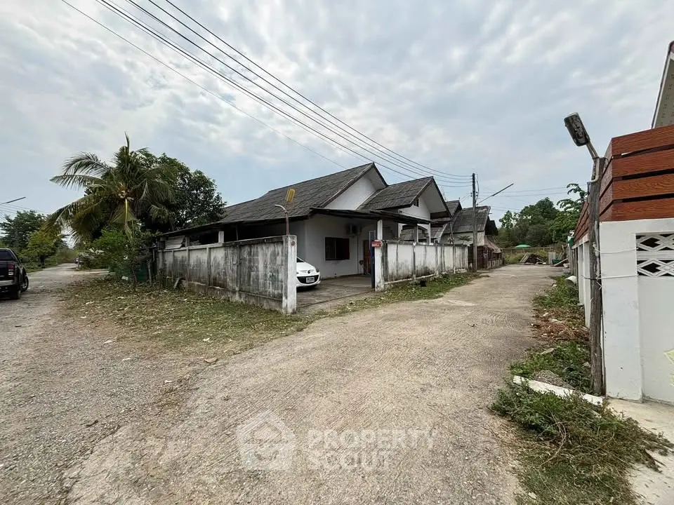 Charming suburban house with spacious driveway and lush greenery, perfect for family living.