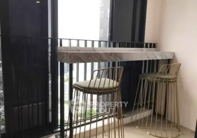 Stylish balcony with modern bar stools and city view, perfect for urban living.