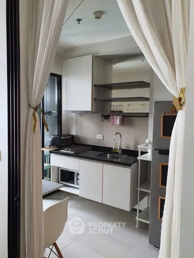 Modern compact kitchen with open layout and sleek appliances