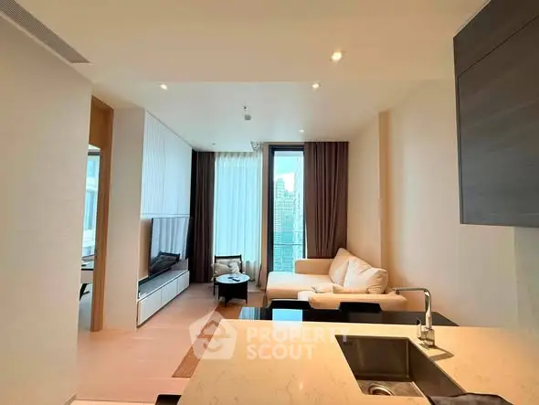 Modern living room with open kitchen and city view, featuring sleek design and cozy seating area.