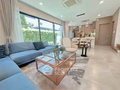Luxurious modern living room with elegant decor and spacious layout, featuring large windows and stylish furniture.