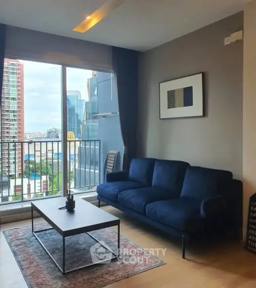 Modern living room with city view, stylish furniture, and large windows for natural light.
