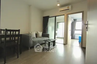 Modern living room with sleek furniture and natural light in a stylish apartment.