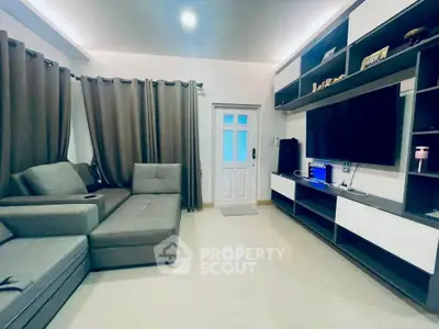 Modern living room with sleek furniture and large TV setup
