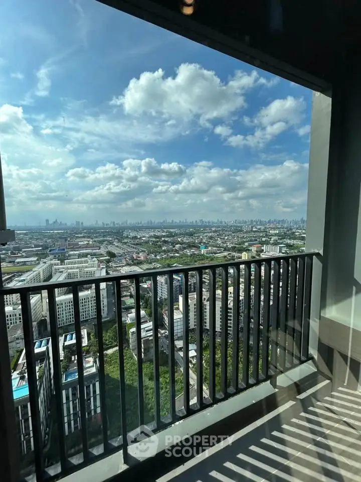 Stunning high-rise balcony view overlooking city skyline and lush greenery.