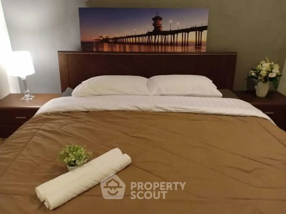 Cozy bedroom with elegant decor and soft lighting, featuring a comfortable bed and stylish artwork.
