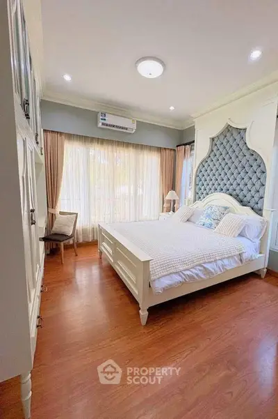 Elegant bedroom with luxurious headboard and natural light