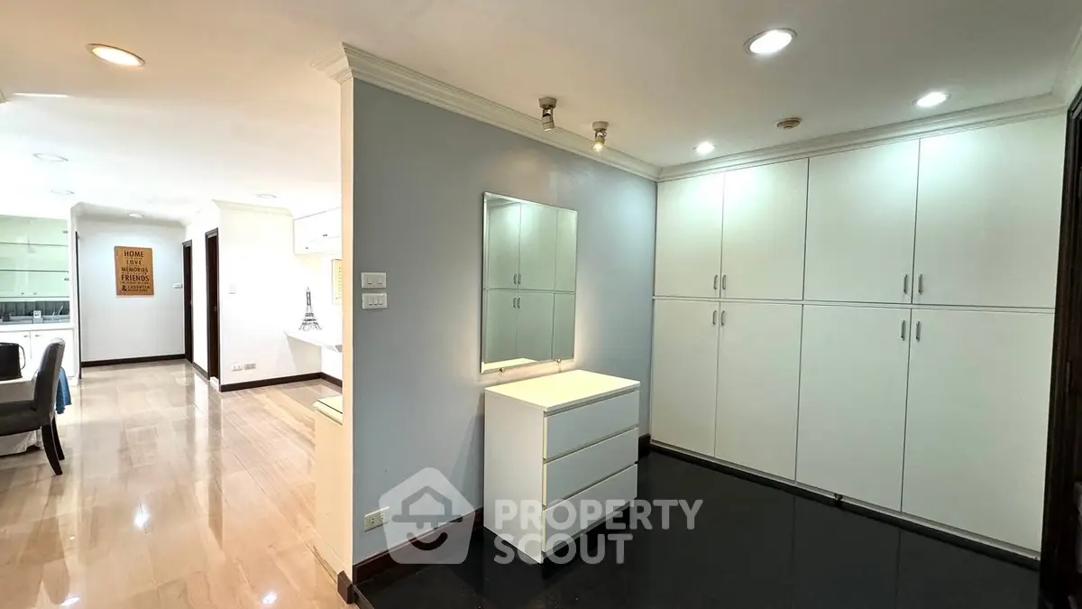 Spacious interior with modern cabinetry and sleek flooring in a stylish apartment.