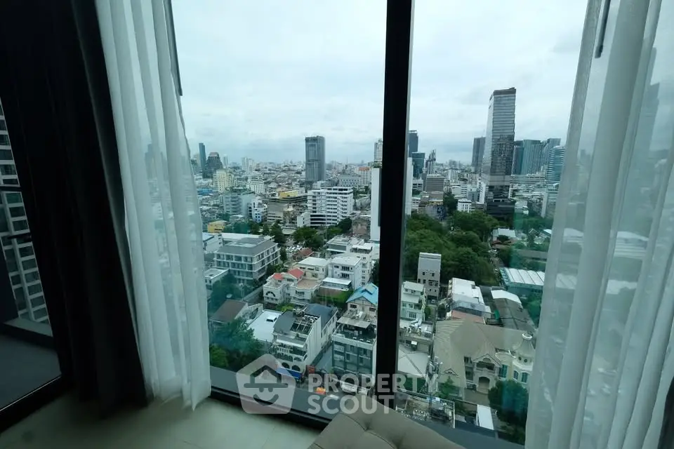 Stunning cityscape view from high-rise apartment window with modern urban skyline.