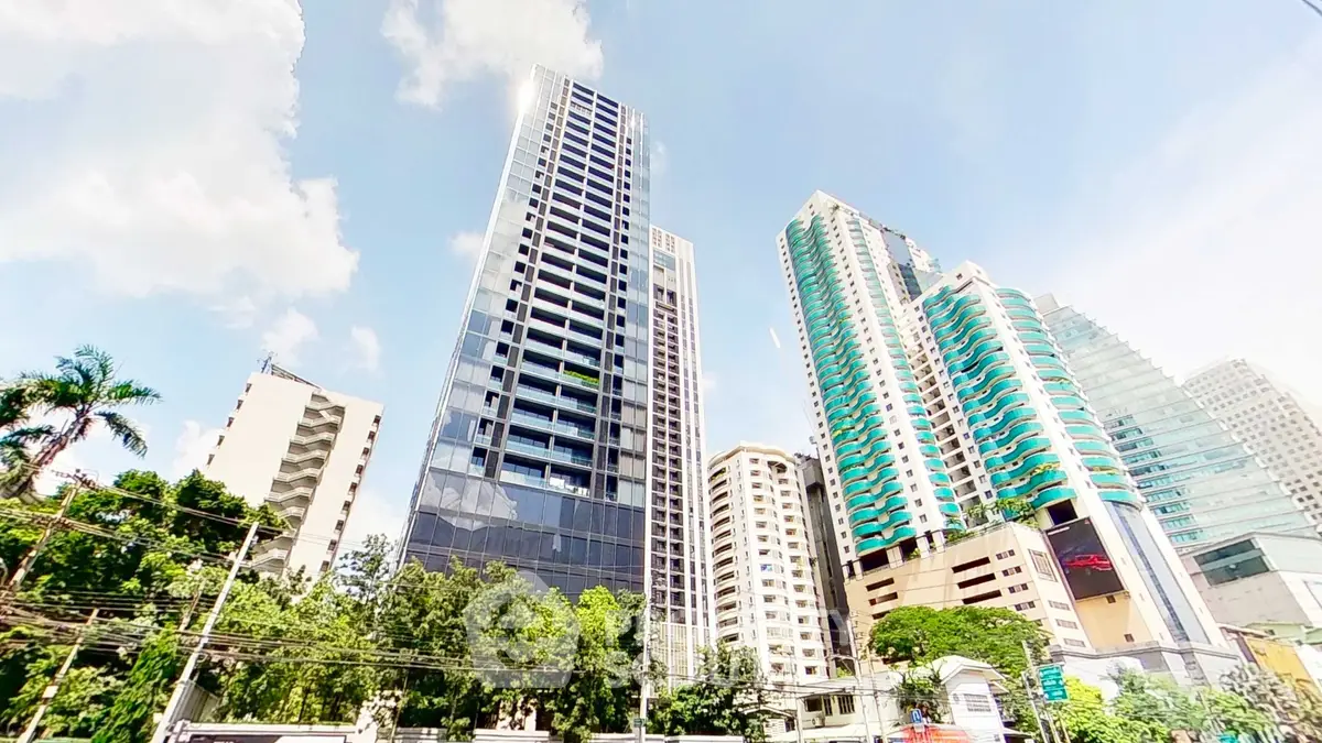 Stunning high-rise buildings with modern architecture and lush greenery in urban setting.