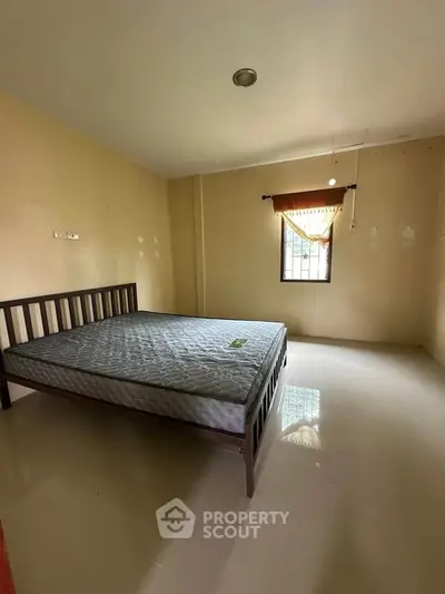 Spacious bedroom with natural light and minimalist design