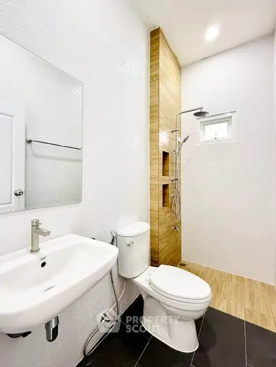 Modern bathroom with sleek fixtures and wooden accents