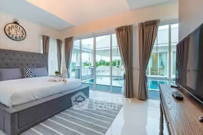 Luxurious bedroom with pool view and elegant decor
