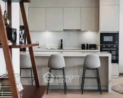 Modern kitchen with sleek cabinetry and stylish bar stools