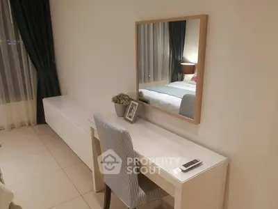 Elegant bedroom with stylish desk and mirror, perfect for modern living.