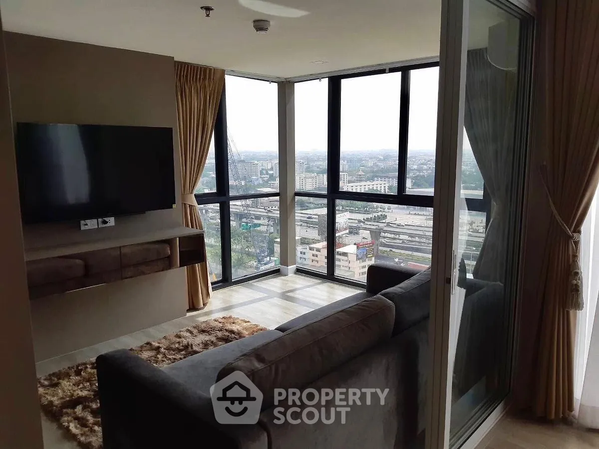 Modern living room with panoramic city view and sleek furnishings.