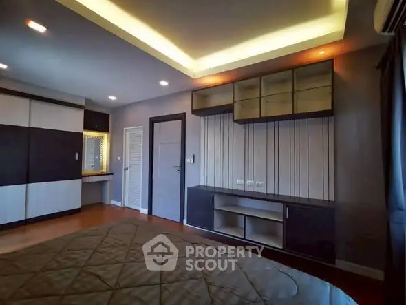 Modern bedroom with stylish built-in furniture and ambient lighting