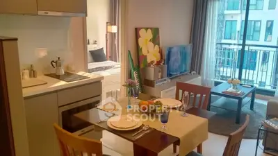 Modern open-plan living room and kitchen with balcony view in urban apartment
