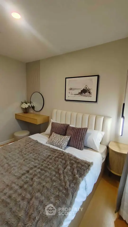 Cozy bedroom with elegant decor and soft lighting, featuring a plush bed and stylish furnishings.