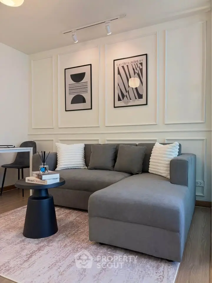 Modern living room with stylish gray sectional sofa and chic wall art, perfect for contemporary urban living.