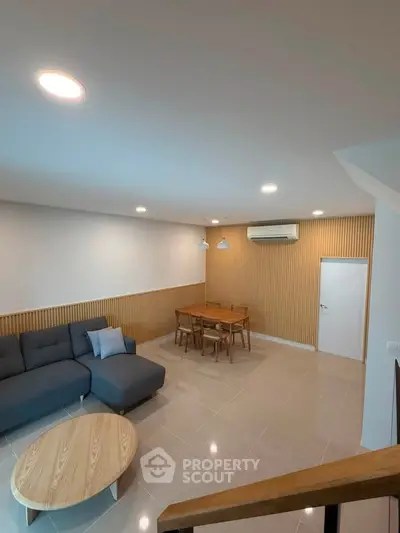 Modern living room with stylish furniture and elegant lighting, perfect for relaxation and entertainment.