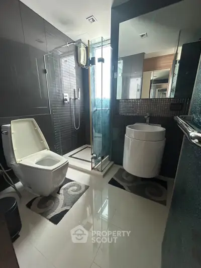 Modern bathroom with sleek design, glass shower, and stylish fixtures in a contemporary home.