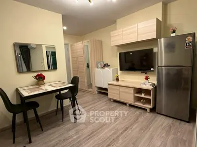 Modern living room with dining area and sleek furniture in cozy apartment.