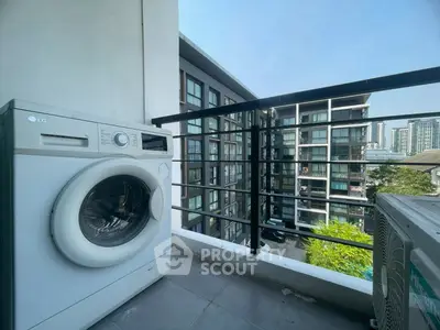 Modern balcony with washing machine and city view, perfect for urban living.