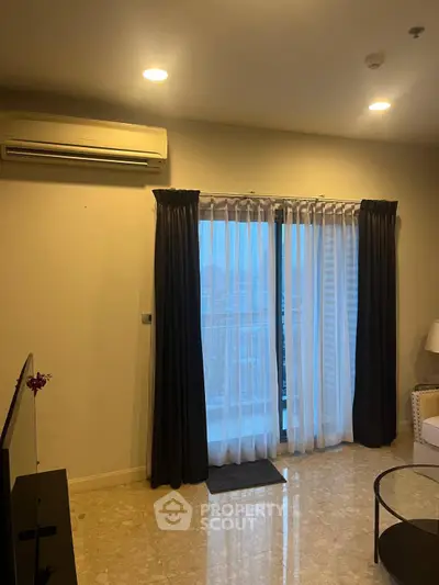 Spacious living room with elegant curtains and air conditioning, perfect for relaxation and comfort.
