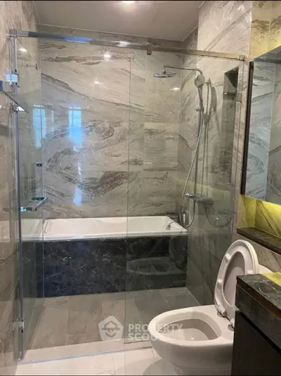 Luxurious modern bathroom with glass shower and elegant marble tiles