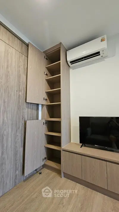 Modern living room with sleek wooden storage and air conditioning