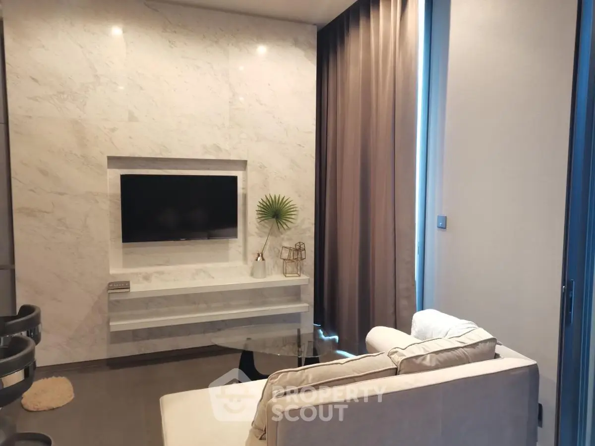 Modern living room with sleek marble wall and cozy seating area