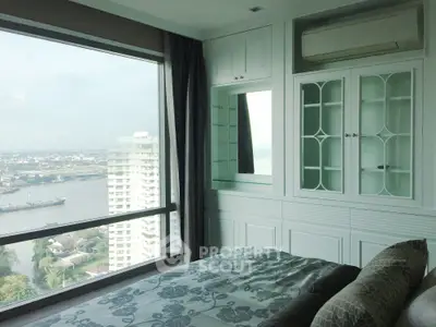 Luxurious bedroom with stunning river view and elegant built-in cabinetry.
