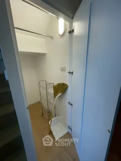 Compact storage space with cleaning tools in modern home
