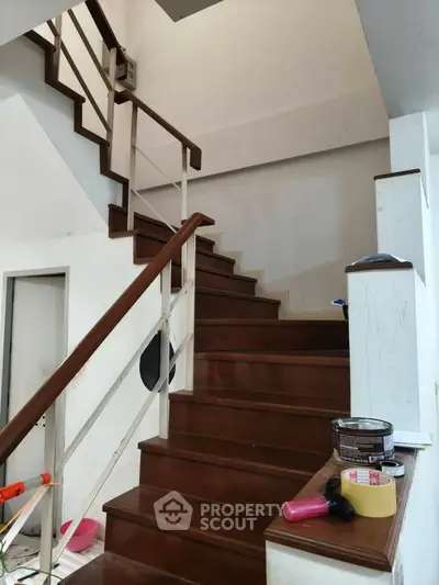 Elegant wooden staircase in modern home interior with sleek railing design