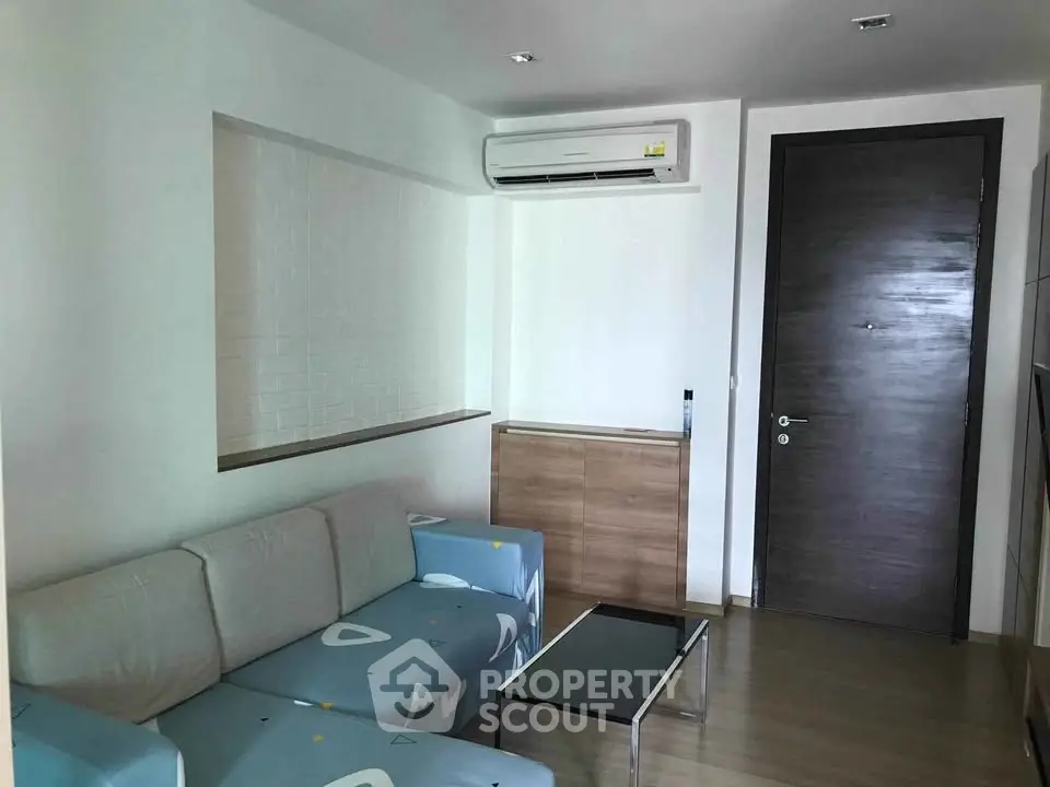 Modern living room with sleek furniture and air conditioning in a stylish apartment.