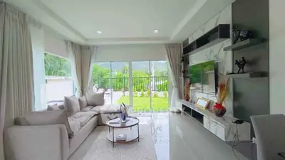 Spacious modern living room with large windows and garden view