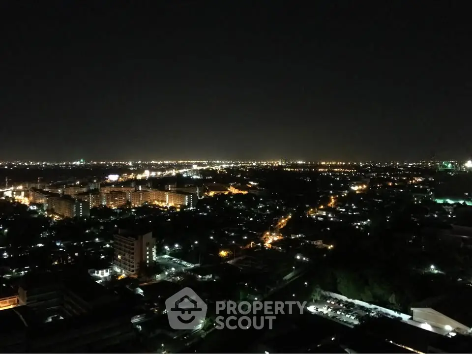 Stunning nighttime cityscape view from a high-rise building, showcasing vibrant city lights.