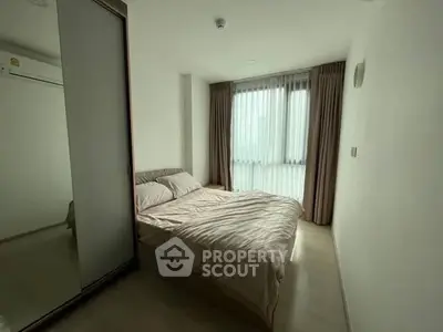 Cozy bedroom with natural light and modern decor in a stylish apartment.