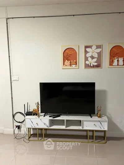 Modern living room with sleek TV stand and decorative wall art