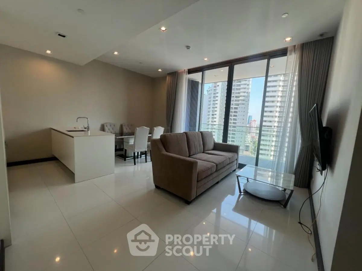 Spacious modern living room with open kitchen and city view balcony