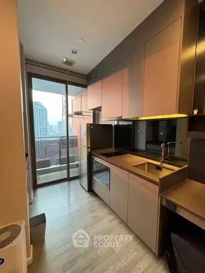 Modern kitchen with sleek cabinetry and city view from balcony
