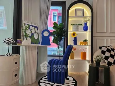 Stylish modern living room with unique blue chair and decorative shelving, perfect for contemporary urban living.